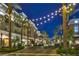 Beautiful community view with palm trees and string lights at dusk, providing a warm and inviting atmosphere at 2185 High Mesa Dr, Henderson, NV 89012