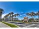 Inviting street view of commercial building with palm trees, ample parking, and lush landscaping at 2185 High Mesa Dr, Henderson, NV 89012