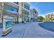 The District features a sidewalk with lush trees, stores and available parking at 2185 High Mesa Dr, Henderson, NV 89012