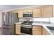 Modern kitchen boasts stainless steel appliances, granite countertops, light wood cabinets and ample counter space for cooking at 2185 High Mesa Dr, Henderson, NV 89012