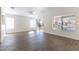 Bright and airy living room with wood-look tile flooring, neutral paint, ceiling fan, and sliding glass doors to backyard at 2185 High Mesa Dr, Henderson, NV 89012