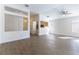 Inviting living room features wood-look tile flooring, neutral paint, ceiling fan, and open layout to the kitchen at 2185 High Mesa Dr, Henderson, NV 89012
