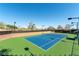 Outdoor tennis court with surrounding greenery and lighting for evening play at 2185 High Mesa Dr, Henderson, NV 89012
