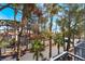 Balcony overlooks palm trees and a quiet street with views of neighboring buildings at 2201 Ramsgate Dr # 128, Henderson, NV 89074