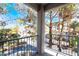 Balcony view of palm trees and building exterior in established community at 2201 Ramsgate Dr # 128, Henderson, NV 89074