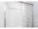 Bathroom featuring a shower-tub, a sliding glass door, and white tile at 2201 Ramsgate Dr # 128, Henderson, NV 89074