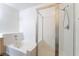 Bright bathroom showcasing a shower with glass door and a corner tub at 2201 Ramsgate Dr # 128, Henderson, NV 89074