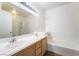 Bathroom featuring double sinks, a bathtub, and a glass door shower at 2201 Ramsgate Dr # 128, Henderson, NV 89074