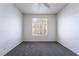 A bedroom with gray carpet and a window view looking out into the neighborhood at 2201 Ramsgate Dr # 128, Henderson, NV 89074