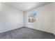 A bedroom with gray carpet and a window view looking out at the palm trees at 2201 Ramsgate Dr # 128, Henderson, NV 89074