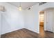 Open bedroom features neutral paint, light fixture, and a view to the bathroom at 2201 Ramsgate Dr # 128, Henderson, NV 89074