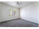 A bedroom with gray carpet and a window view looking out at the palm trees at 2201 Ramsgate Dr # 128, Henderson, NV 89074