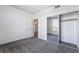 Bedroom with mirrored closet doors and doorway to the kitchen at 2201 Ramsgate Dr # 128, Henderson, NV 89074