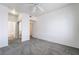 A bedroom with a ceiling fan, carpeted floors, and a view into the bathroom at 2201 Ramsgate Dr # 128, Henderson, NV 89074
