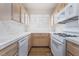 Galley kitchen with white appliances, light wood cabinets, and lots of natural light at 2201 Ramsgate Dr # 128, Henderson, NV 89074