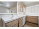 Bright kitchen with wood cabinetry, white tile countertops and partial view to the living room at 2201 Ramsgate Dr # 128, Henderson, NV 89074