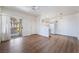 Open-concept living room with sliding glass door to patio, ceiling fan and modern light-colored wood floors at 2201 Ramsgate Dr # 128, Henderson, NV 89074