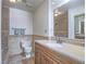 Bathroom features a light-toned stone shower, single vanity with stone countertop, and a decorative border around the room at 2462 Pickwick Dr, Henderson, NV 89014
