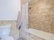 Cozy bathroom with shower-tub combo and tiled walls at 2462 Pickwick Dr, Henderson, NV 89014