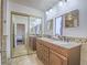 Double vanity bathroom featuring decorative tile and updated fixtures at 2462 Pickwick Dr, Henderson, NV 89014
