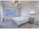 Bright bedroom with a leafy print bedspread, window and ceiling fan at 2462 Pickwick Dr, Henderson, NV 89014