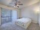 Cozy bedroom with a sliding glass door, a leafy print bedspread and ceiling fan at 2462 Pickwick Dr, Henderson, NV 89014