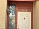 Charming front door with a glass side panel and decorative house numbers at 2462 Pickwick Dr, Henderson, NV 89014