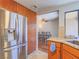 Well-equipped kitchen featuring stainless steel refrigerator and cabinetry adjacent to the dining area at 2462 Pickwick Dr, Henderson, NV 89014