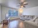 Spacious living room with hardwood floors, large window, neutral colors, and ceiling fan at 2462 Pickwick Dr, Henderson, NV 89014