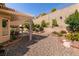 Backyard featuring a covered patio, desert landscaping and a brick retaining wall at 2521 Roseworthy Dr, Las Vegas, NV 89134