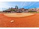 A baseball field with the backdrop of houses and trees at 2521 Roseworthy Dr, Las Vegas, NV 89134