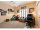 Cozy bedroom with a window, plush carpeting, and comfortable seating, perfect for relaxation at 2521 Roseworthy Dr, Las Vegas, NV 89134