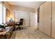 Bright bedroom with a built-in wardrobe, large window, carpet flooring, and a study desk at 2521 Roseworthy Dr, Las Vegas, NV 89134