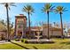 Exterior of beautiful clubhouse with fountain, tall palm trees, and a stucco finish at 2521 Roseworthy Dr, Las Vegas, NV 89134