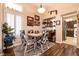Dining area featuring wood floors, a round table, and bright natural lighting at 2521 Roseworthy Dr, Las Vegas, NV 89134