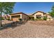 Charming single-story home with desert landscaping, a two-car garage, and a tile roof at 2521 Roseworthy Dr, Las Vegas, NV 89134