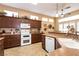 An eat-in kitchen features tile floors, a double oven, granite countertops, and bright lighting at 2521 Roseworthy Dr, Las Vegas, NV 89134