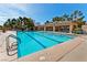 A large community pool with ample seating surrounded by beautiful trees on a sunny day at 2521 Roseworthy Dr, Las Vegas, NV 89134