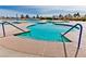 A large community pool with ample seating surrounded by beautiful trees on a sunny day at 2521 Roseworthy Dr, Las Vegas, NV 89134