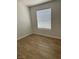 Bright room featuring wood floors, white walls and a window with modern white blinds at 2528 Sierra Bello Ave # 103, Las Vegas, NV 89106