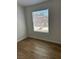 Bright bedroom features hardwood flooring and natural light through window at 2528 Sierra Bello Ave # 103, Las Vegas, NV 89106
