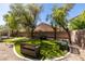 Serene backyard featuring an artificial lawn, benches, and gravel landscaping at 2543 Farmington Ave, Las Vegas, NV 89120