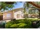 Extensive backyard with an artificial lawn, putting green, and a covered patio at 2543 Farmington Ave, Las Vegas, NV 89120
