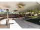 Covered patio featuring ceiling fans, a built-in fire pit, and ample seating at 2543 Farmington Ave, Las Vegas, NV 89120