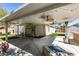Spacious backyard patio with a fire pit, built-in bar, and a cozy porch swing at 2543 Farmington Ave, Las Vegas, NV 89120