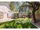 Beautiful backyard with a putting green, covered patio, and well-maintained landscaping, perfect for outdoor entertaining at 2543 Farmington Ave, Las Vegas, NV 89120