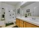 Bathroom with double sinks, tiled shower, and green accents at 2543 Farmington Ave, Las Vegas, NV 89120