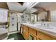 Bright bathroom features a glass shower, a soaking tub, and and sinks at 2543 Farmington Ave, Las Vegas, NV 89120