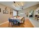 Spacious dining area featuring a long table, wood floors, and stylish lighting fixtures at 2543 Farmington Ave, Las Vegas, NV 89120