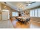 Well-lit dining room boasts stylish lighting, tile/wood floors, and access to multiple rooms at 2543 Farmington Ave, Las Vegas, NV 89120